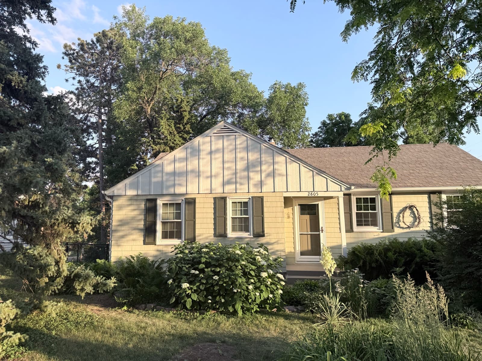 Bungalow front at golden hour with new gable siding