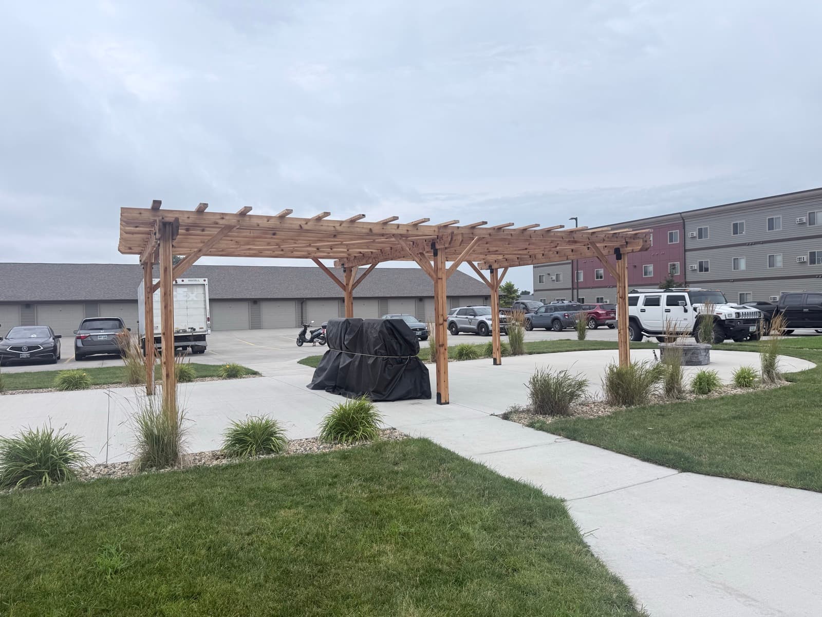 Custom cedar pergola over a landscaped commercial courtyard