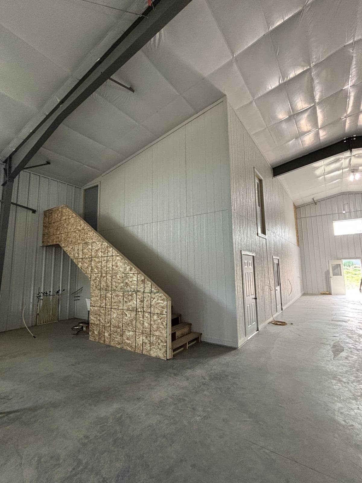 Finished shop interior with a clad office mezzanine and sealed concrete floor