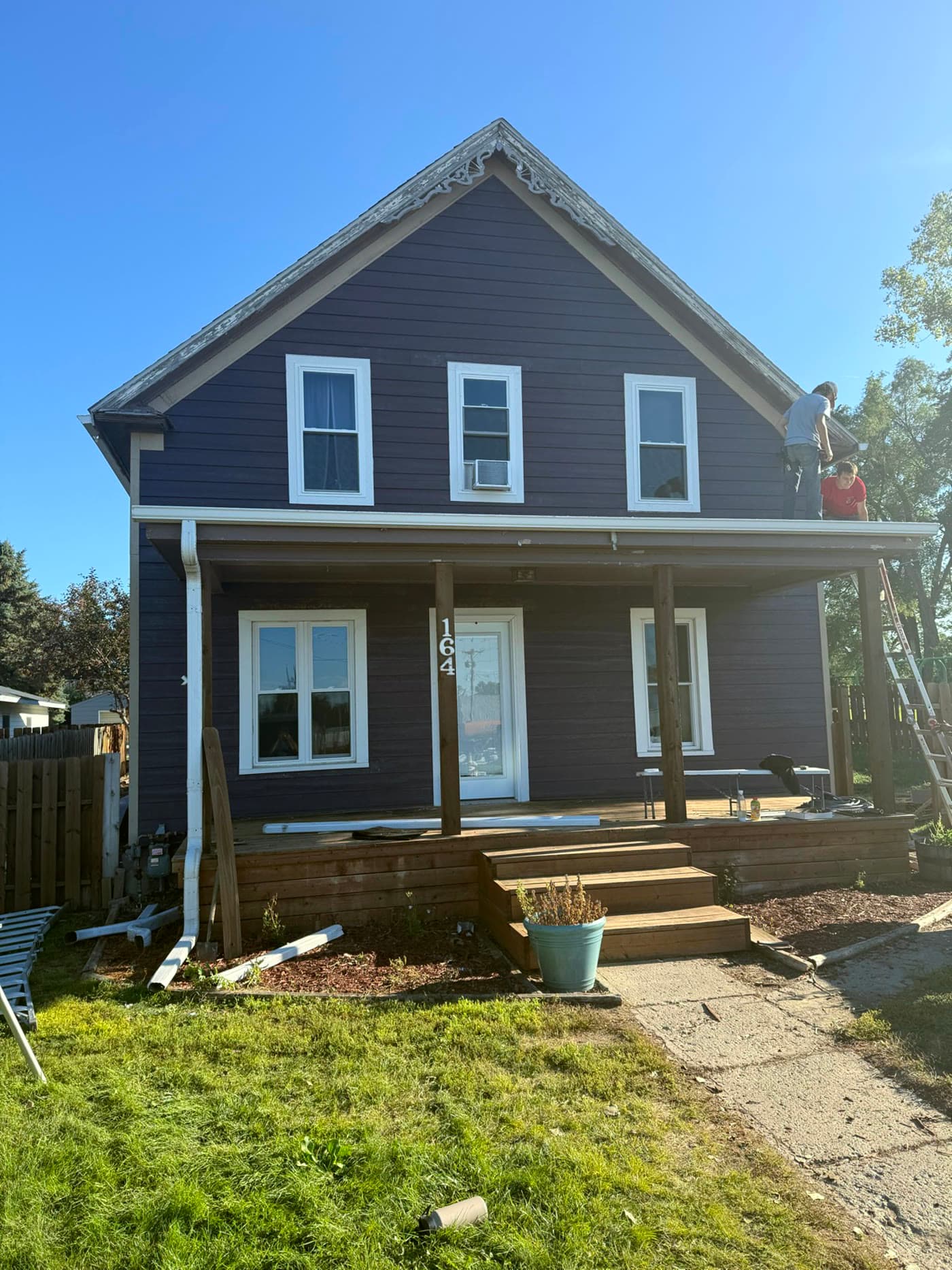 Completed home exterior with new navy siding