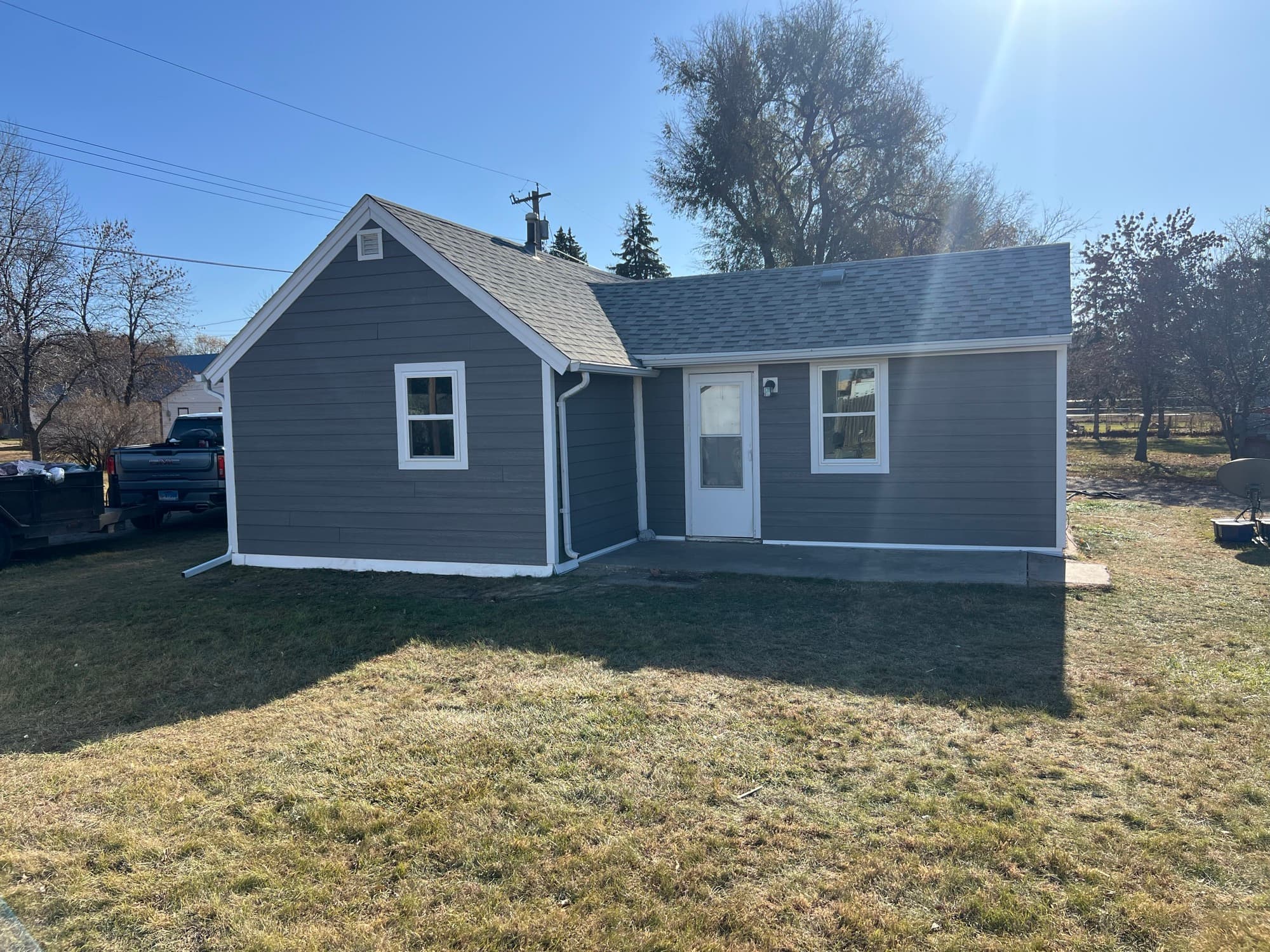 Home exterior with new gray siding and white trim